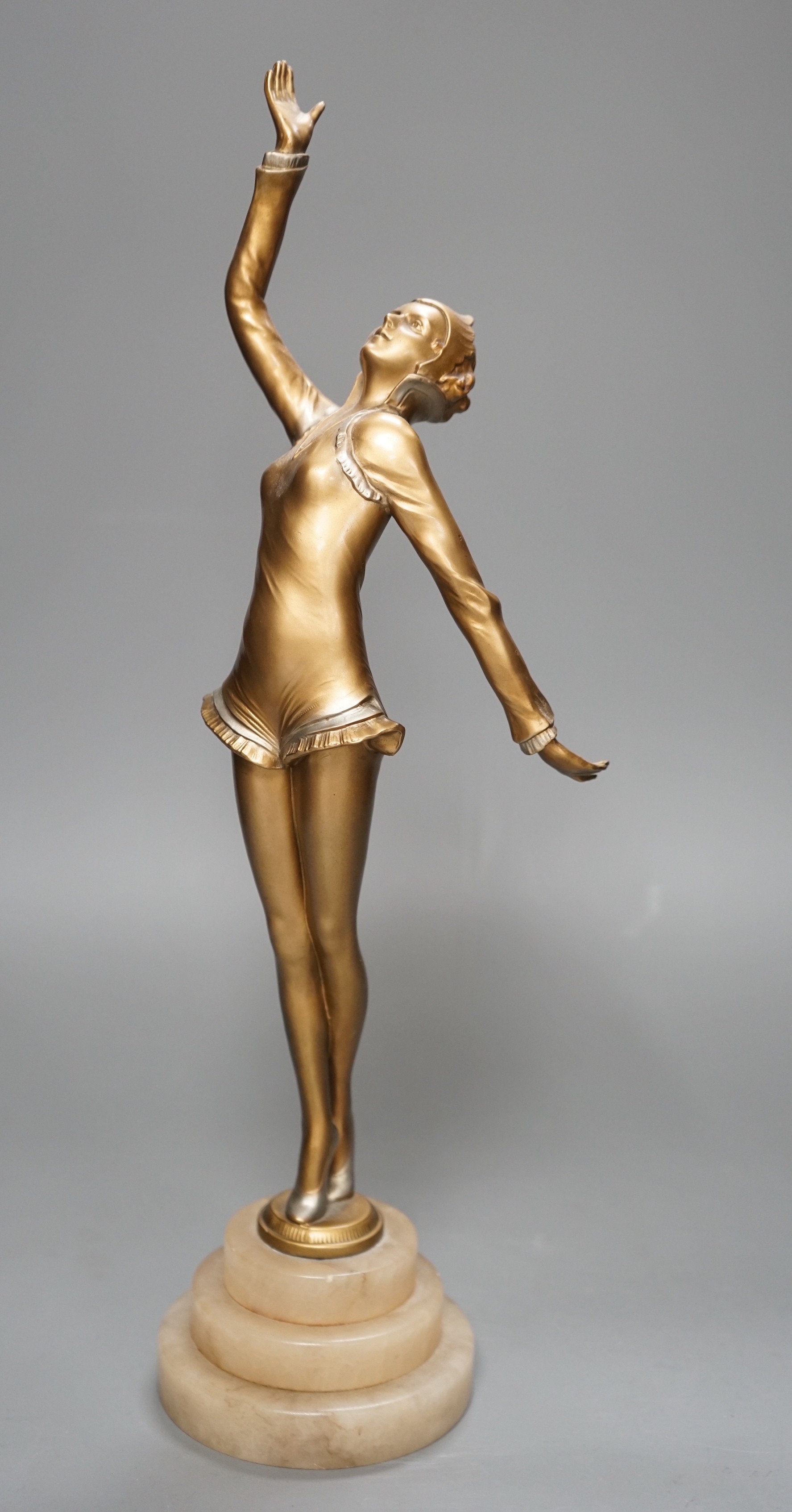 An Art Deco gilt metal model of a dancer, on stepped alabaster base, 41cm
